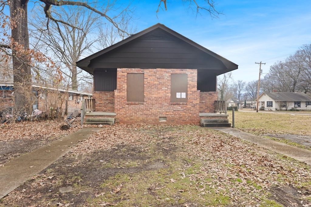 view of front facade with crawl space and brick siding
