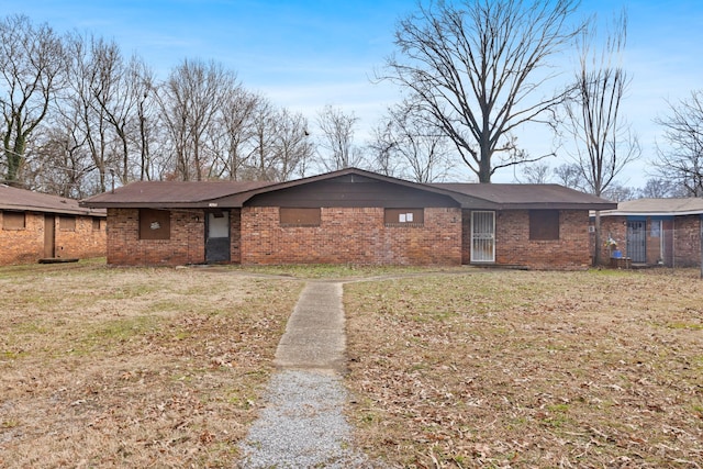 ranch-style home with brick siding and a front lawn