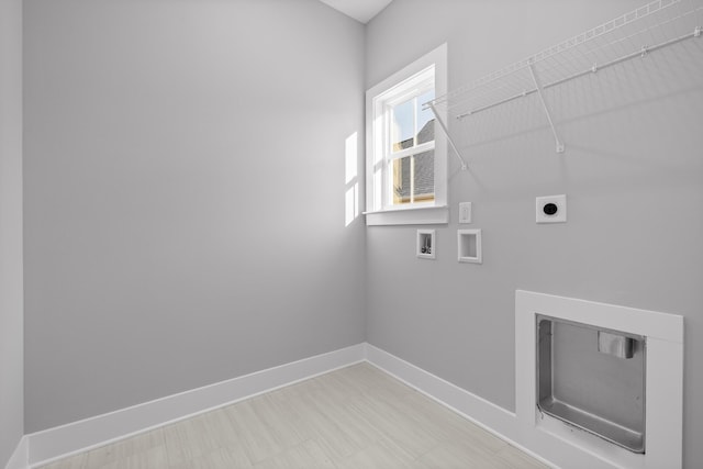 clothes washing area with laundry area, baseboards, washer hookup, and electric dryer hookup