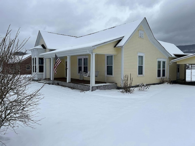 snow covered house with a porch