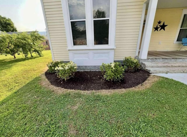 entrance to property with a lawn