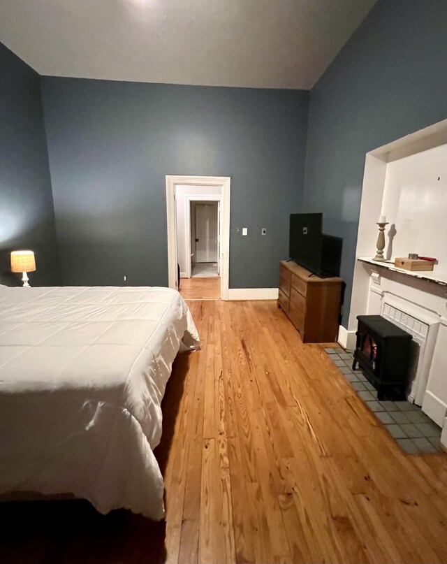 bedroom with light wood finished floors and baseboards