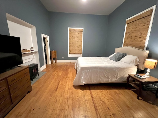 bedroom with baseboards and light wood finished floors