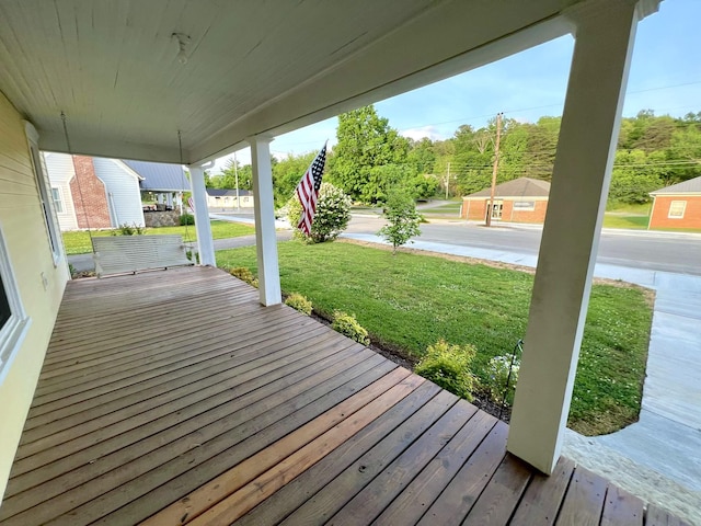 deck featuring a yard and covered porch
