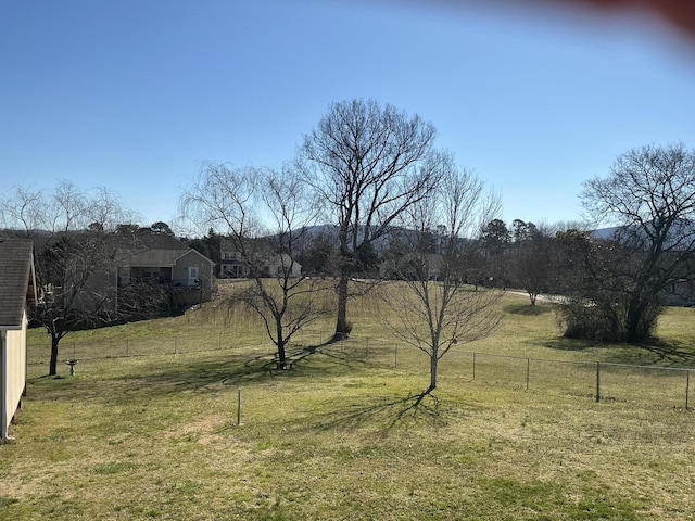 view of yard with a rural view and fence