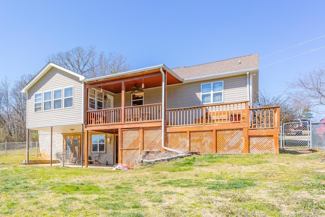 back of property featuring a patio area, a lawn, fence, and a wooden deck