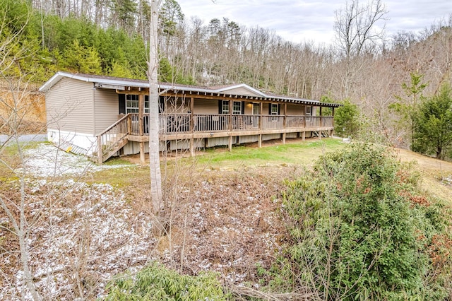 rear view of property with a forest view