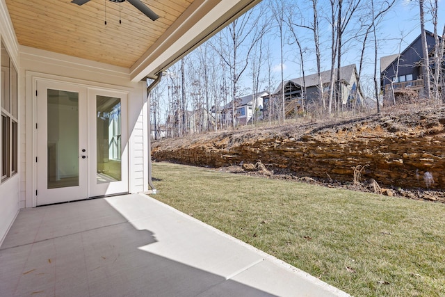 view of yard featuring ceiling fan, a patio, and french doors