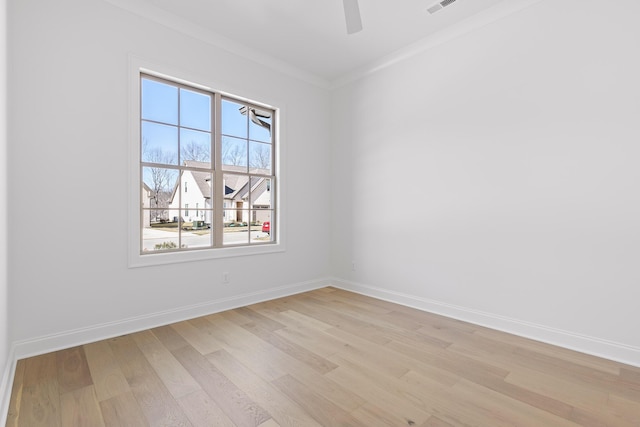 unfurnished room featuring light wood finished floors, ceiling fan, baseboards, and ornamental molding