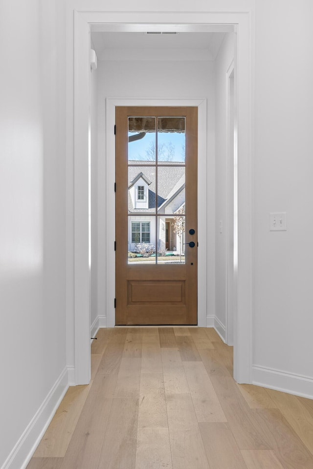 doorway to outside featuring light wood-type flooring and baseboards