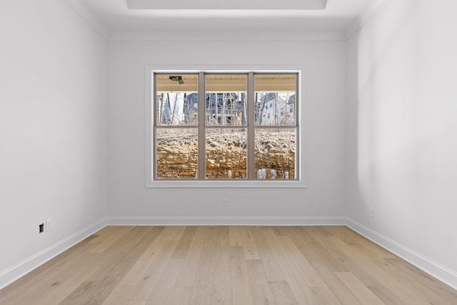 spare room with light wood-type flooring and baseboards