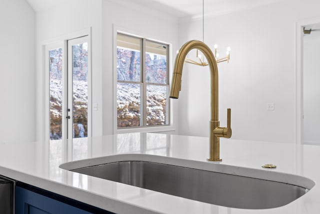 interior details with light countertops, a sink, and blue cabinetry