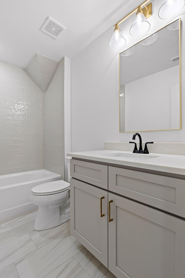 bathroom with toilet, vanity, visible vents, marble finish floor, and washtub / shower combination