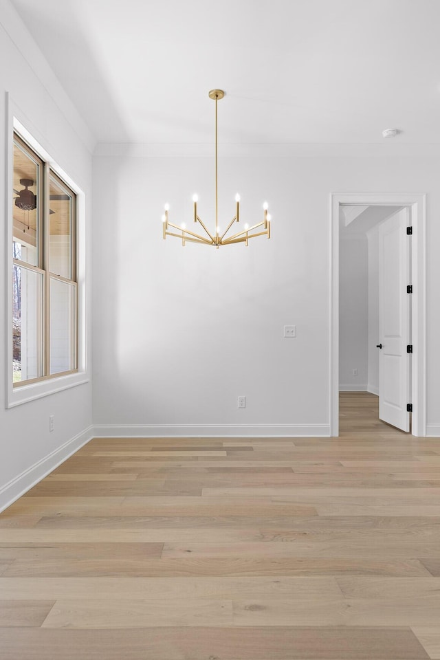 unfurnished dining area with light wood-style floors, baseboards, and a chandelier