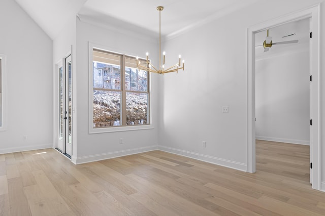 unfurnished dining area featuring light wood-style floors, a notable chandelier, and baseboards