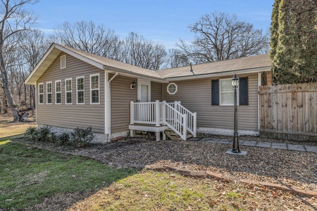 ranch-style house with fence