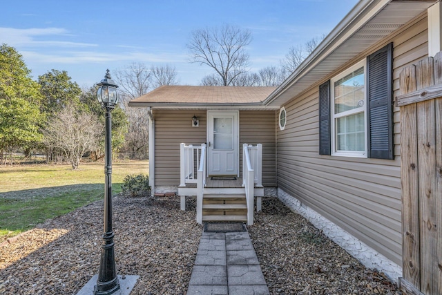 doorway to property featuring a yard