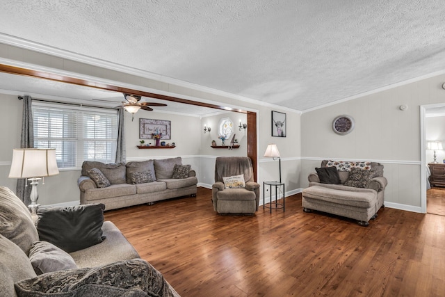 living area with crown molding, a textured ceiling, and wood finished floors