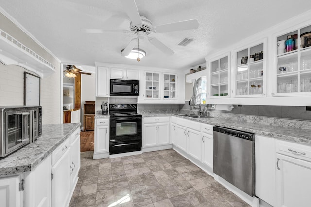 kitchen featuring black appliances, visible vents, and white cabinets