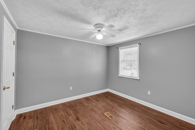 unfurnished room with a ceiling fan, crown molding, visible vents, and wood finished floors