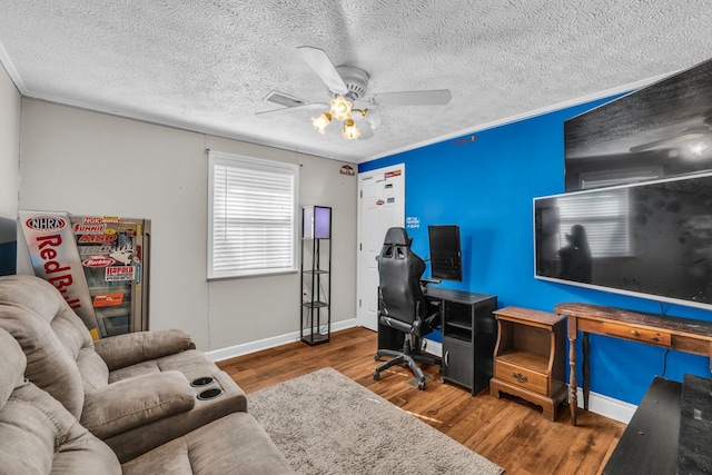 office area with a ceiling fan, dark wood-style flooring, ornamental molding, and baseboards