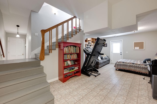 bedroom with baseboards and tile patterned floors