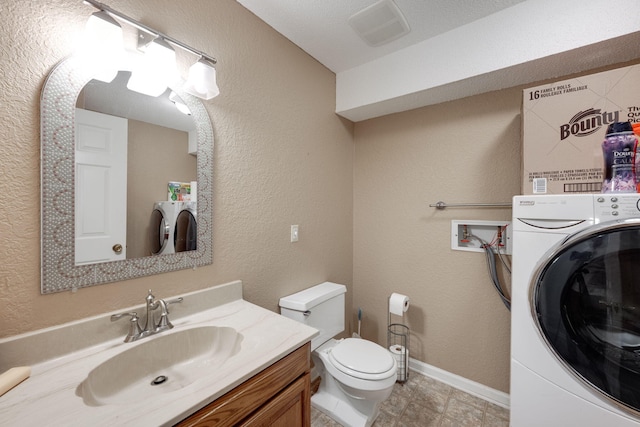 bathroom featuring washer / dryer, baseboards, a textured wall, toilet, and vanity