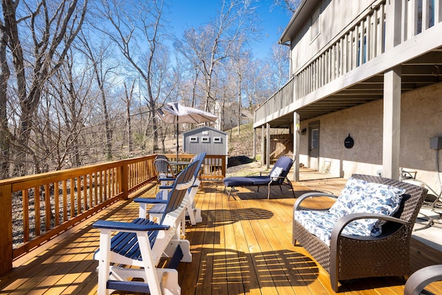 wooden terrace with an outdoor structure and a storage unit