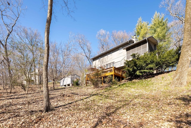 exterior space with a sunroom and a wooden deck