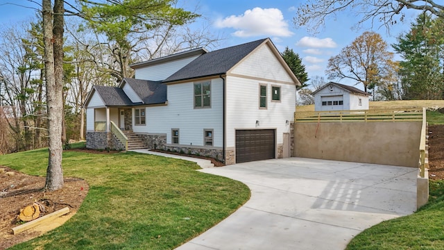 exterior space with driveway, stone siding, roof with shingles, a yard, and a garage