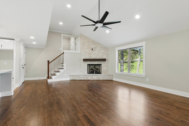 unfurnished living room with dark wood-style floors, recessed lighting, stairway, ceiling fan, and a stone fireplace