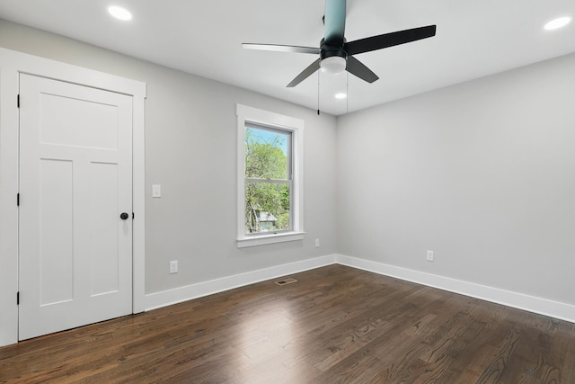 spare room featuring ceiling fan, visible vents, baseboards, recessed lighting, and dark wood finished floors