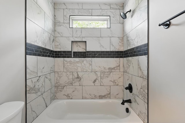 bathroom with toilet and shower / bathing tub combination