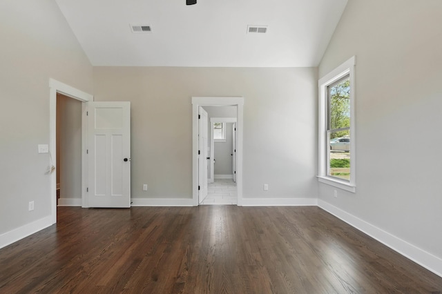 unfurnished bedroom with visible vents, multiple windows, and lofted ceiling