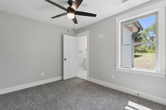 unfurnished bedroom featuring carpet, visible vents, a ceiling fan, and baseboards