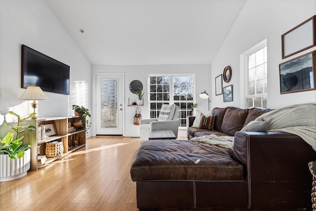 living area featuring light wood-style floors and lofted ceiling