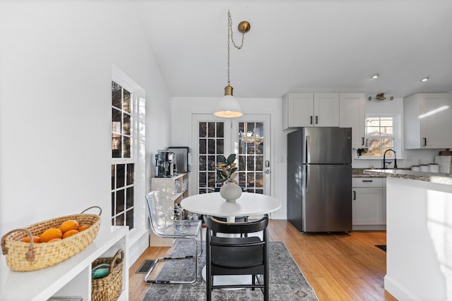 dining space with light wood-style flooring