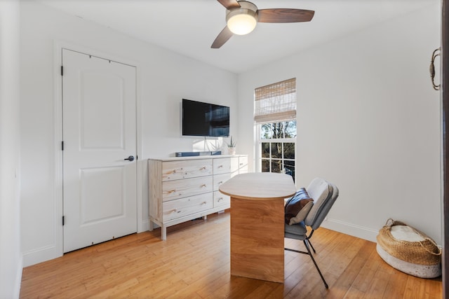 office with light wood-type flooring, baseboards, and a ceiling fan