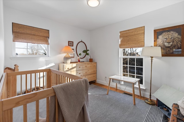 bedroom with baseboards and wood finished floors