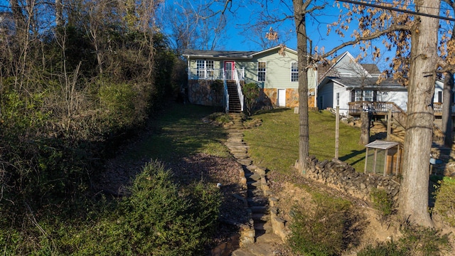 view of yard featuring a deck and stairs