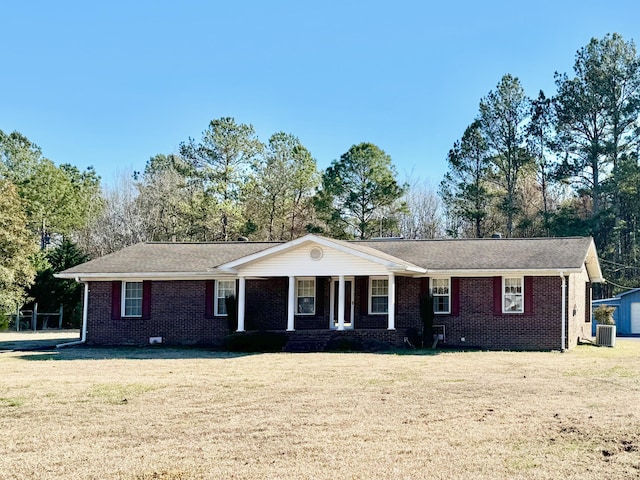 ranch-style house with a front lawn, a porch, brick siding, and central air condition unit