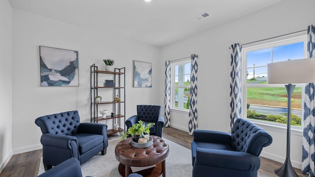 sitting room featuring plenty of natural light, wood finished floors, and visible vents