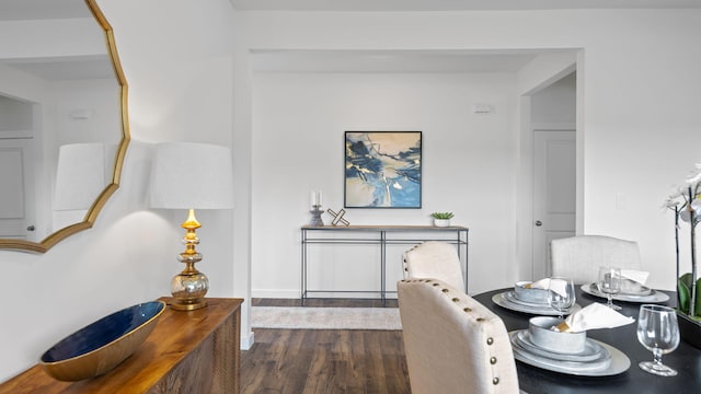 dining space with dark wood-style floors and baseboards