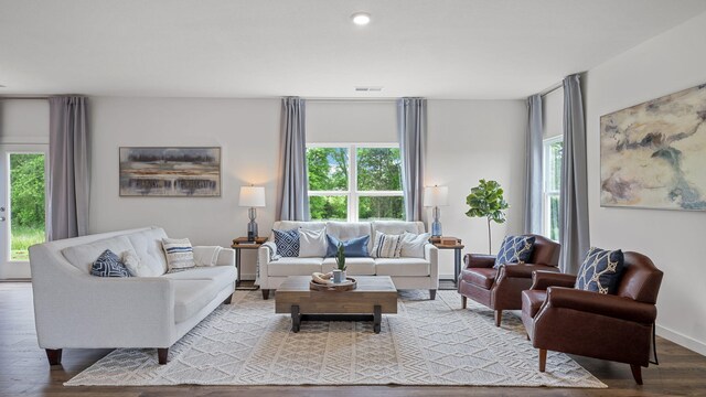 living area with recessed lighting, visible vents, and light wood finished floors