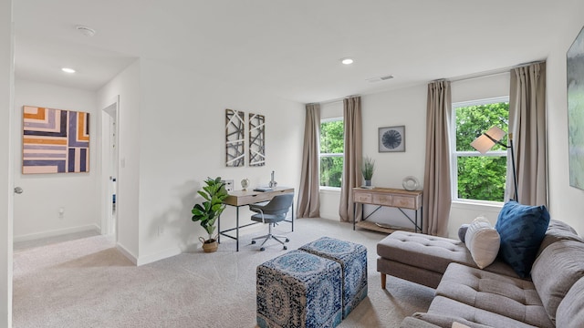 living area with light carpet, baseboards, visible vents, and recessed lighting