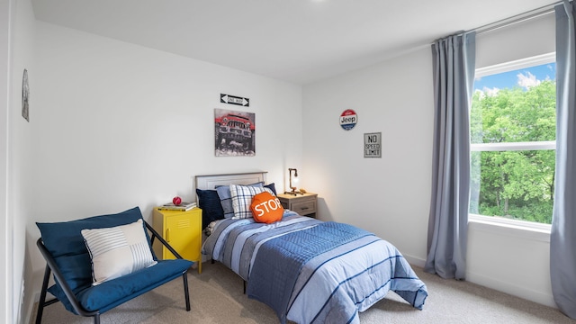 bedroom with carpet floors and baseboards