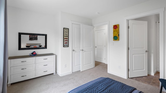 unfurnished bedroom with light colored carpet and baseboards