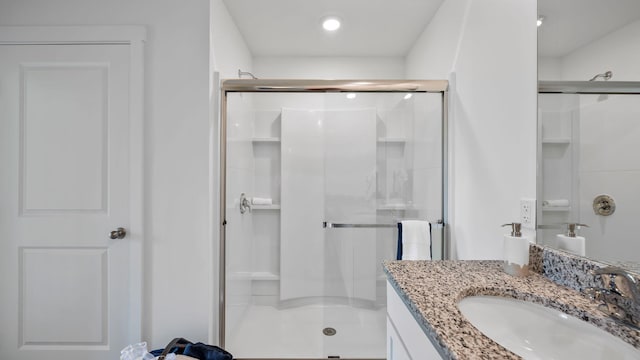 bathroom featuring a shower stall and vanity