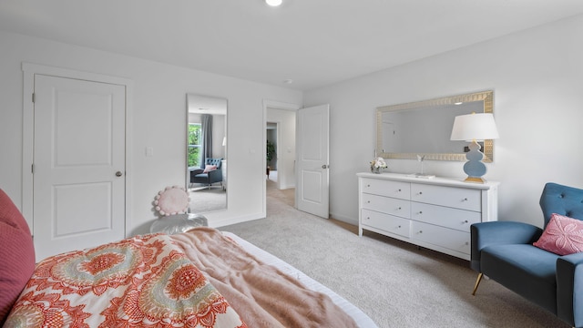 bedroom featuring baseboards and light colored carpet