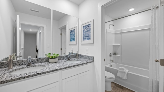 full bathroom featuring toilet, shower / washtub combination, a sink, and visible vents